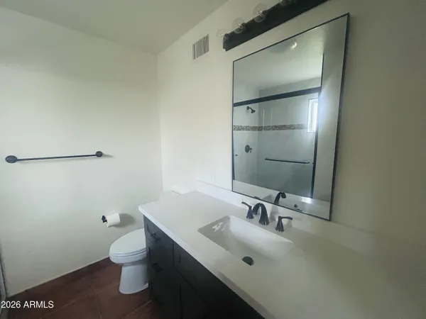 a bathroom with a glass shower door