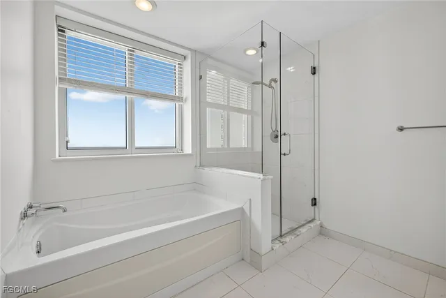 a bathroom with a bathtub and a shower