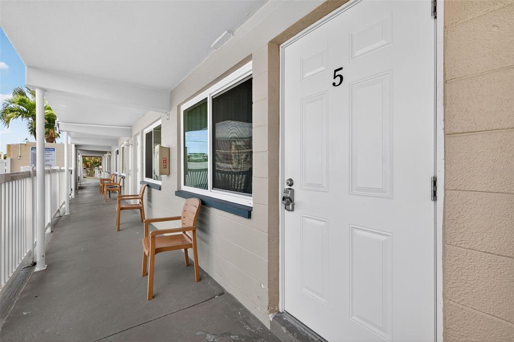 14251 Gulf Boulevard, Unit 5 Madeira Beach, FL 33708 - Photo 4 of 19 a view of a livingroom with furniture and floor to ceiling window