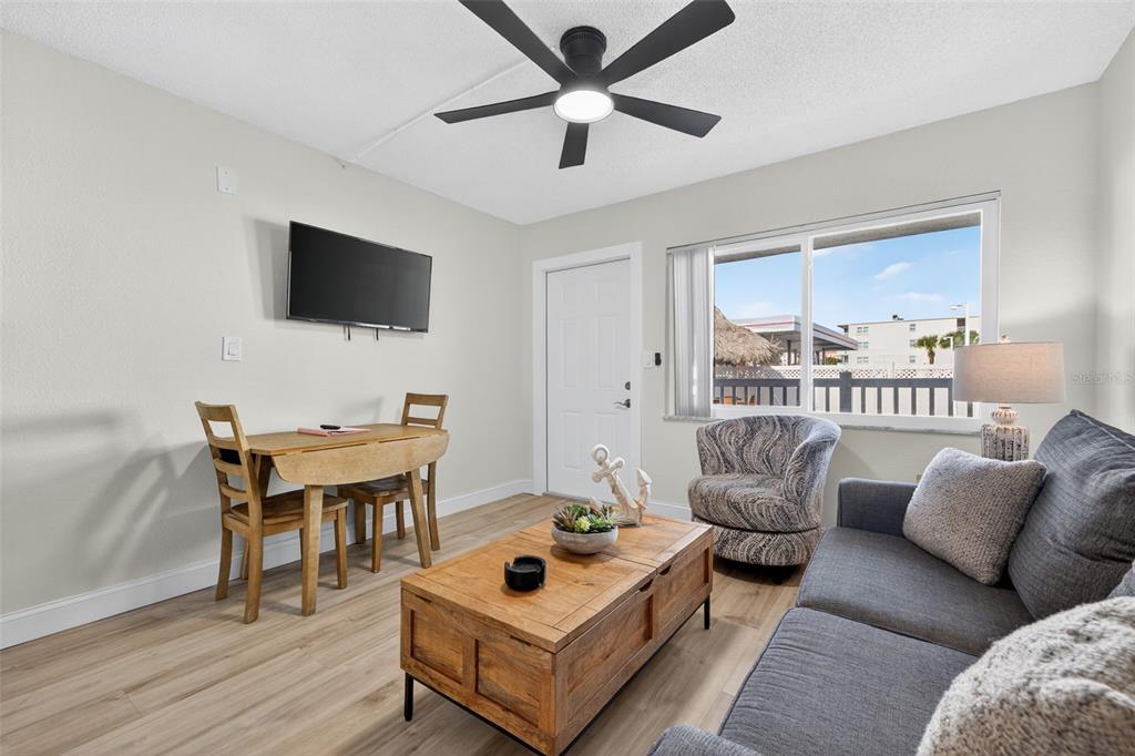 14251 Gulf Boulevard, Unit 5 Madeira Beach, FL 33708 - Photo 8 of 19 a living room with furniture and a flat screen tv