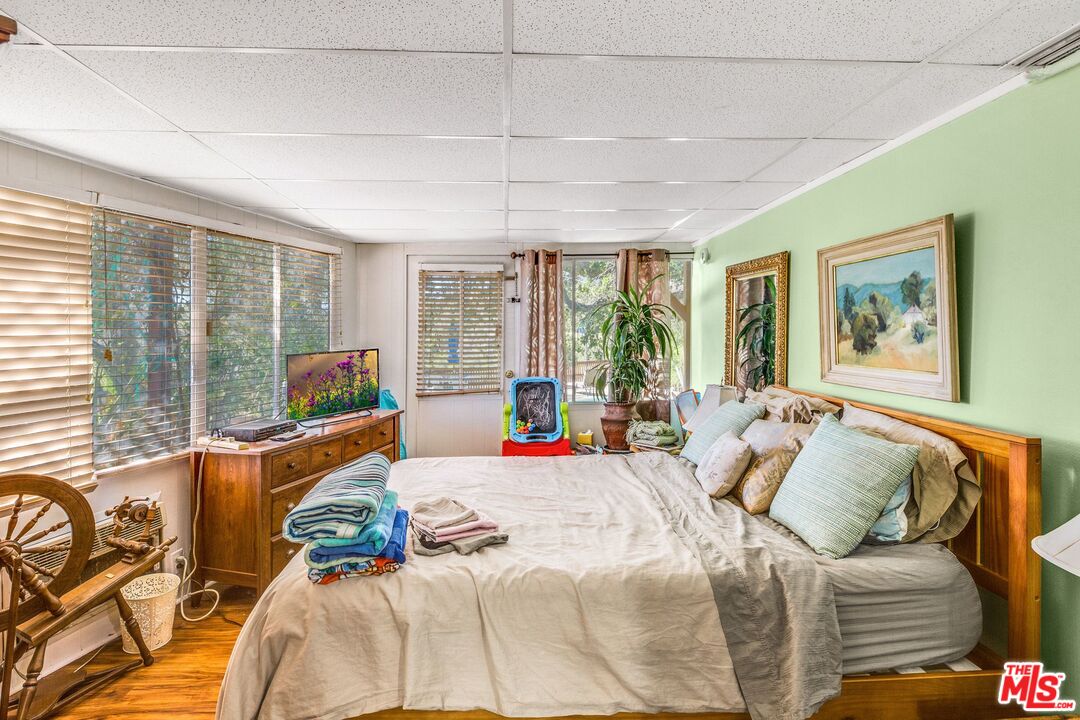 4183 Aralia Road Altadena, CA 91001 - Photo 15 of 40 a bedroom with furniture and large windows