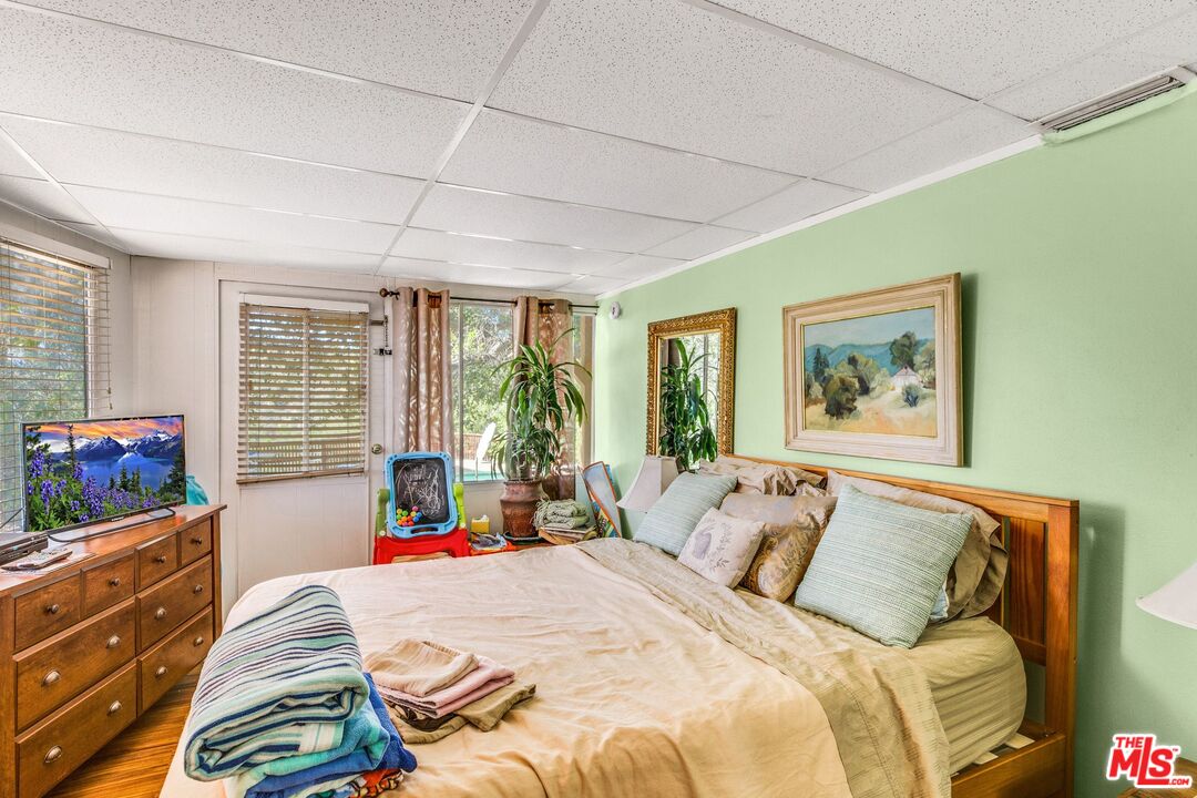 4183 Aralia Road Altadena, CA 91001 - Photo 16 of 40 a bedroom with a bed and a large window