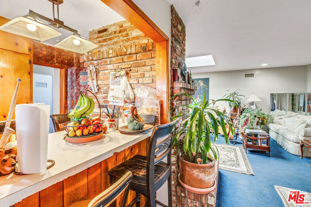 4183 Aralia Road Altadena, CA 91001 - Photo 18 of 40 a dining room filled with lots of furniture and potted plants