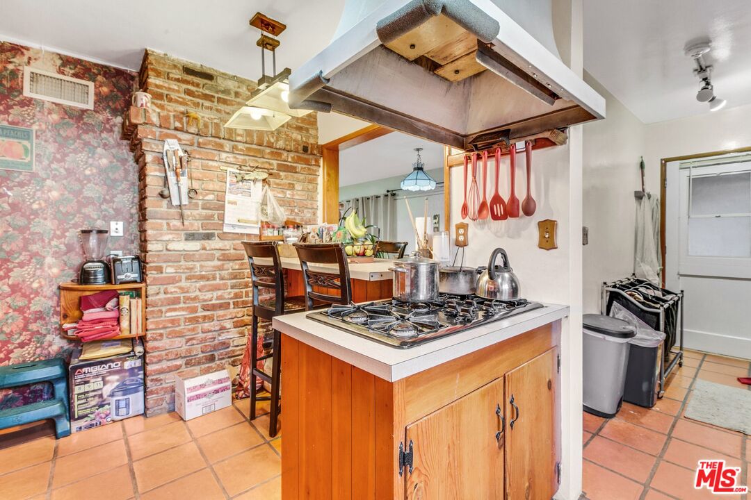 4183 Aralia Road Altadena, CA 91001 - Photo 22 of 40 a kitchen that has a lot of cabinets in it