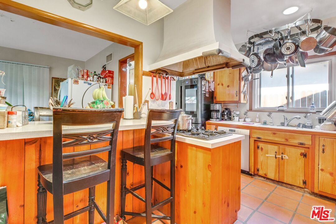 4183 Aralia Road Altadena, CA 91001 - Photo 23 of 40 a kitchen with stainless steel appliances granite countertop a sink and cabinets