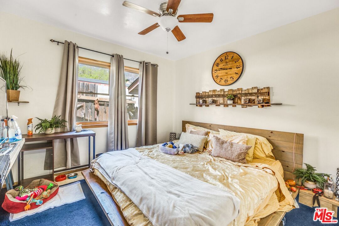 4183 Aralia Road Altadena, CA 91001 - Photo 26 of 40 a bedroom with a bed and a chandelier