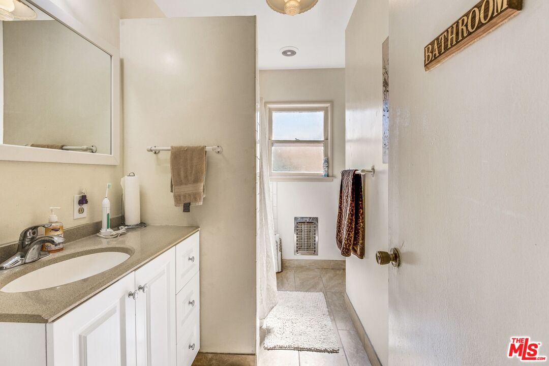 4183 Aralia Road Altadena, CA 91001 - Photo 28 of 40 a bathroom with a sink vanity granite tub and shower