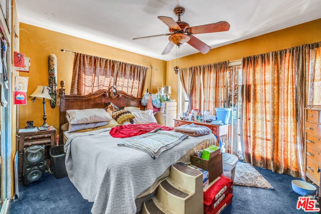 4183 Aralia Road Altadena, CA 91001 - Photo 29 of 40 a bed room with a bed mirror and a window