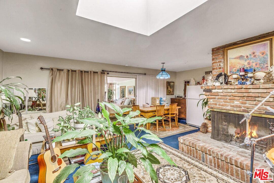 4183 Aralia Road Altadena, CA 91001 - Photo 8 of 40 a living room with fireplace furniture and a large window