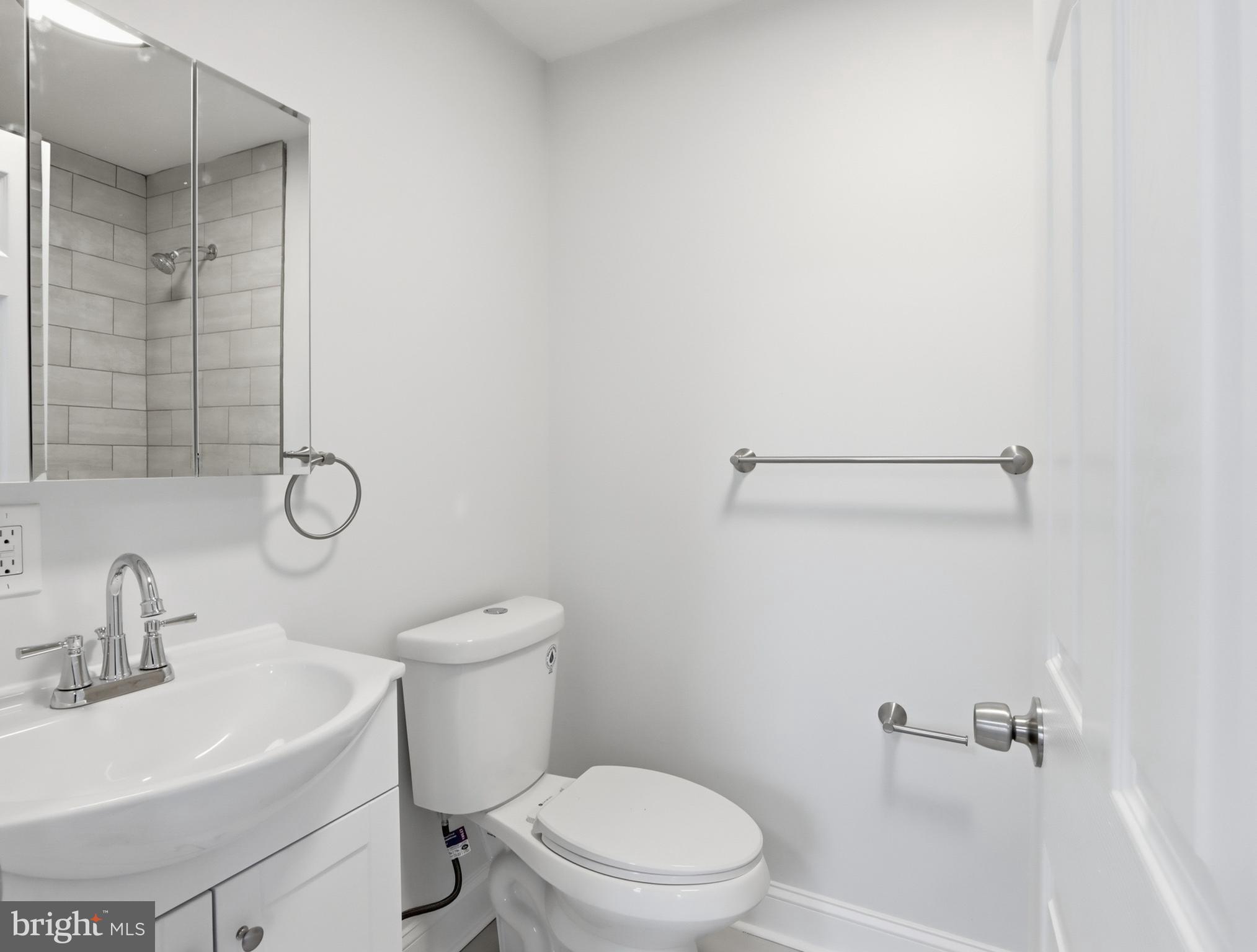 932 East 41st Street Baltimore, MD 21218 - Photo 20 of 51 a white toilet sitting next to a bathroom sink