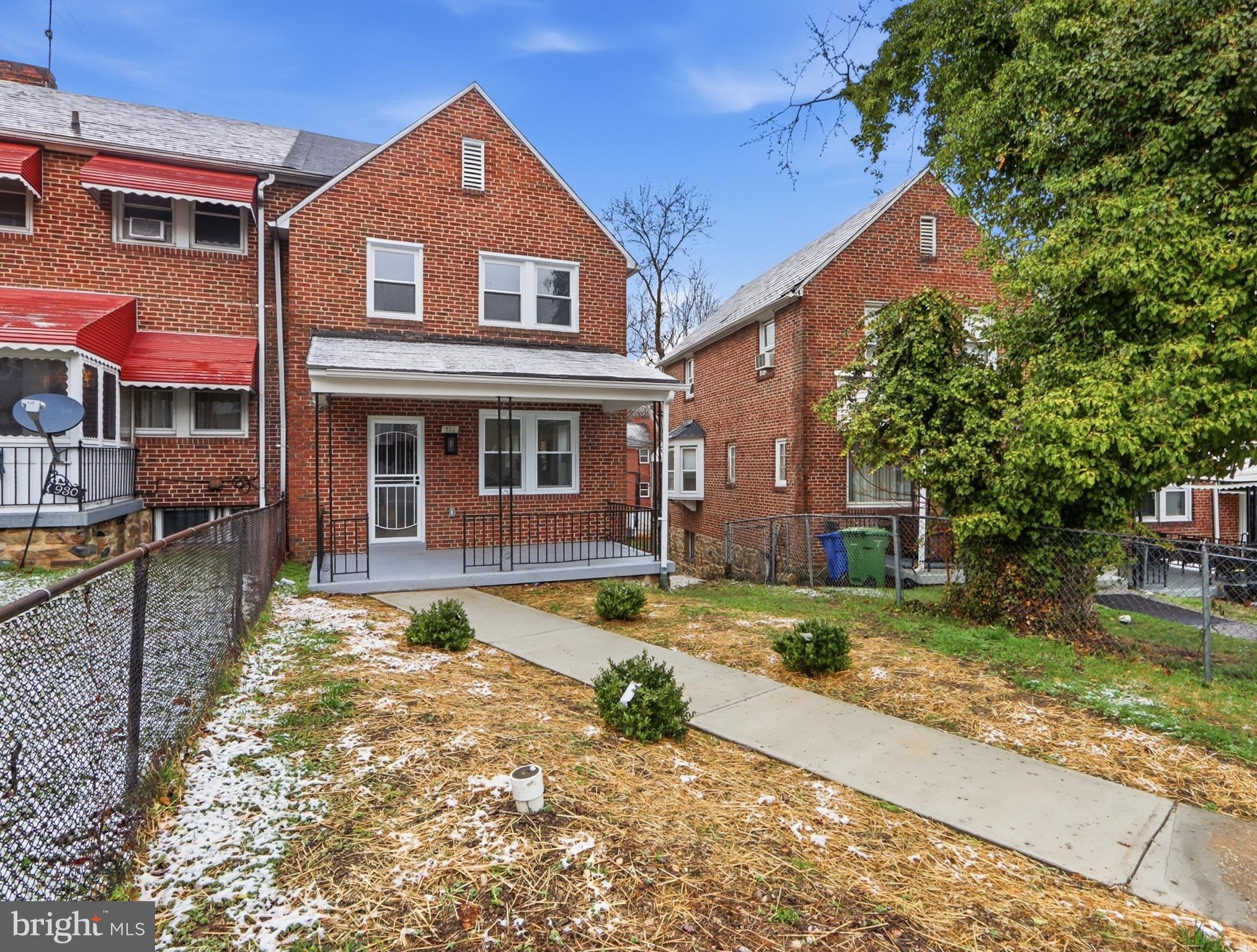 932 East 41st Street Baltimore, MD 21218 - Photo 4 of 51 a front view of a house with garden