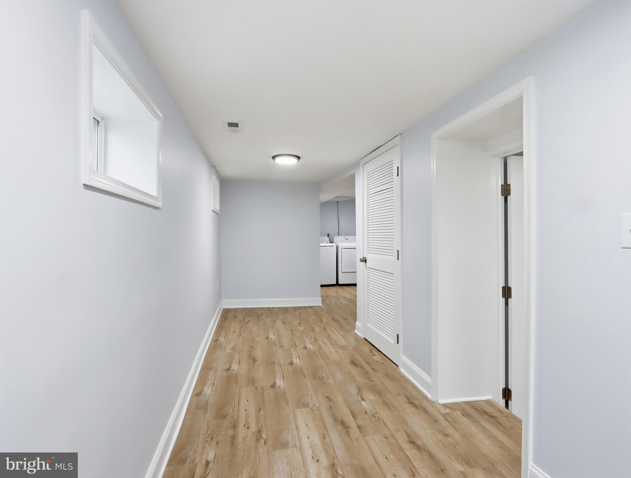 932 East 41st Street Baltimore, MD 21218 - Photo 42 of 51 a view of empty room with wooden floor