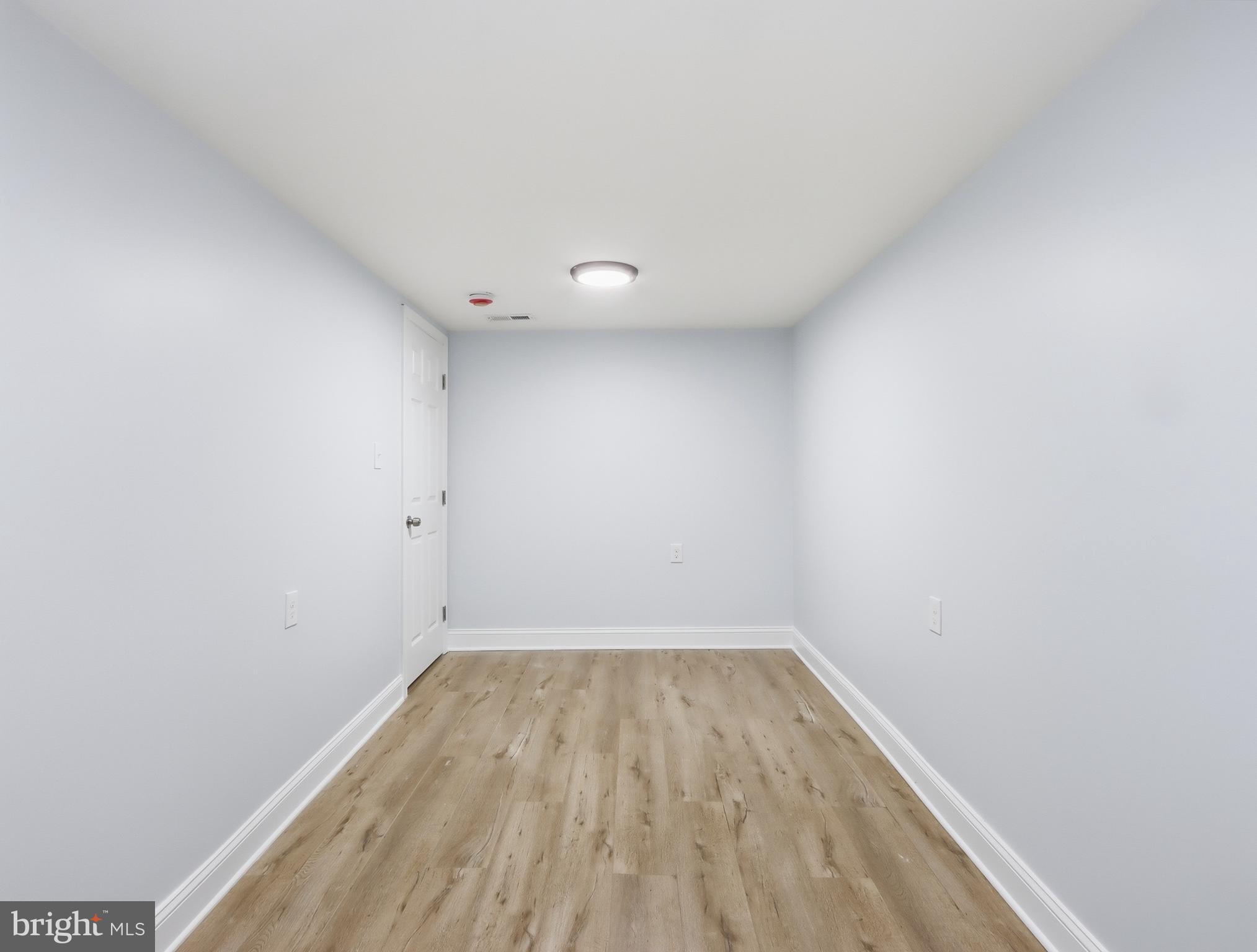 932 East 41st Street Baltimore, MD 21218 - Photo 44 of 51 a view of room with wooden floor
