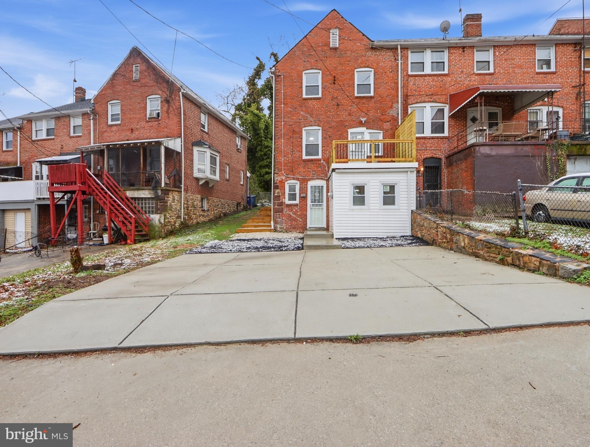 932 East 41st Street Baltimore, MD 21218 - Photo 49 of 51 a front view of a house with a yard