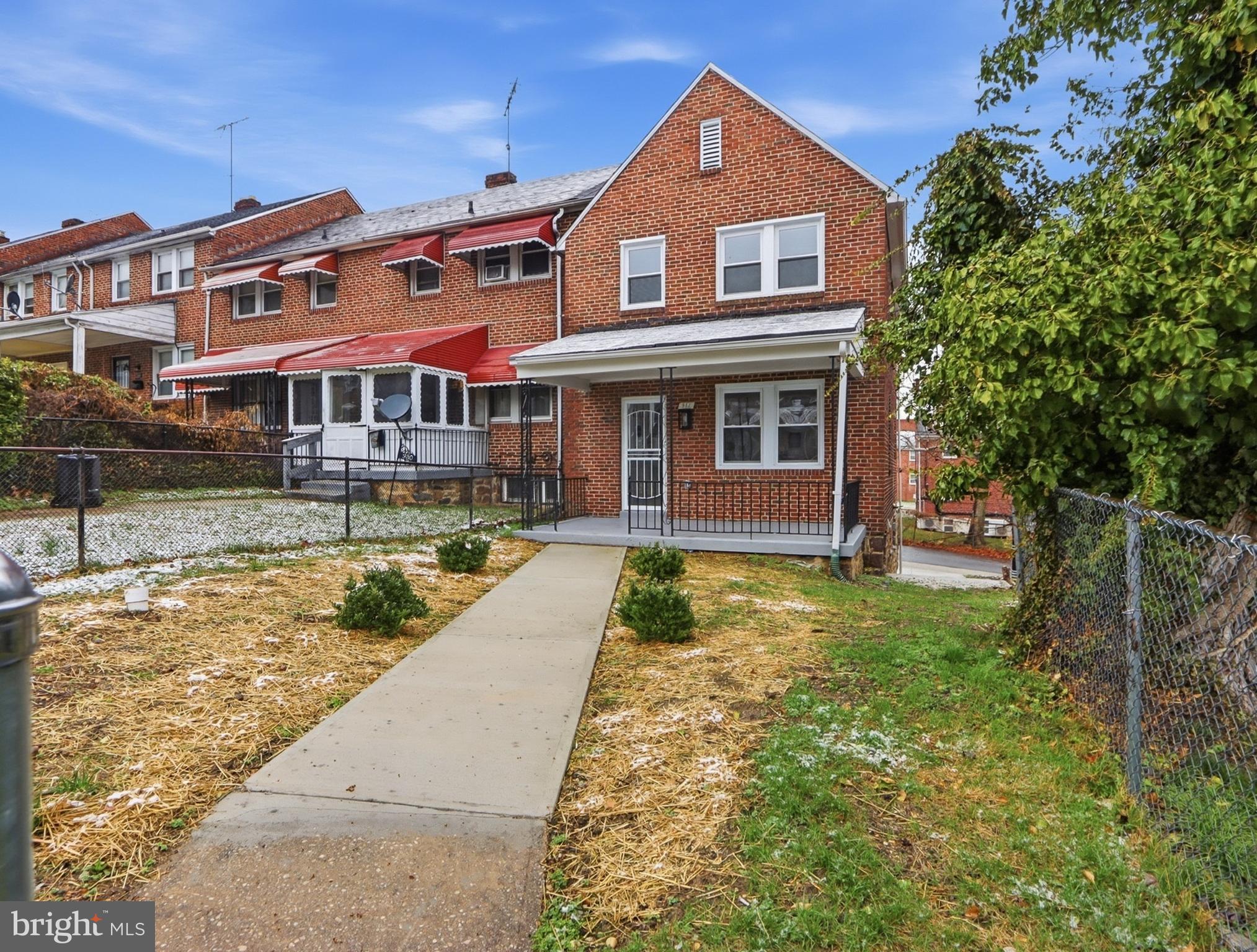 932 East 41st Street Baltimore, MD 21218 - Photo 5 of 51 a front view of a house with a yard