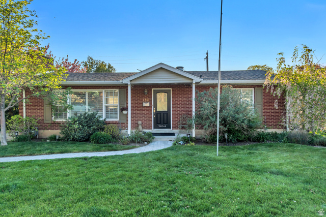 1240 Westwood Road Bountiful, UT 84010 - Photo 1 of 1 Single story home featuring a front yard, brick siding, and a shingled roof