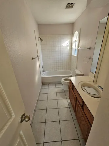 a bathroom with a sink a toilet and a shower