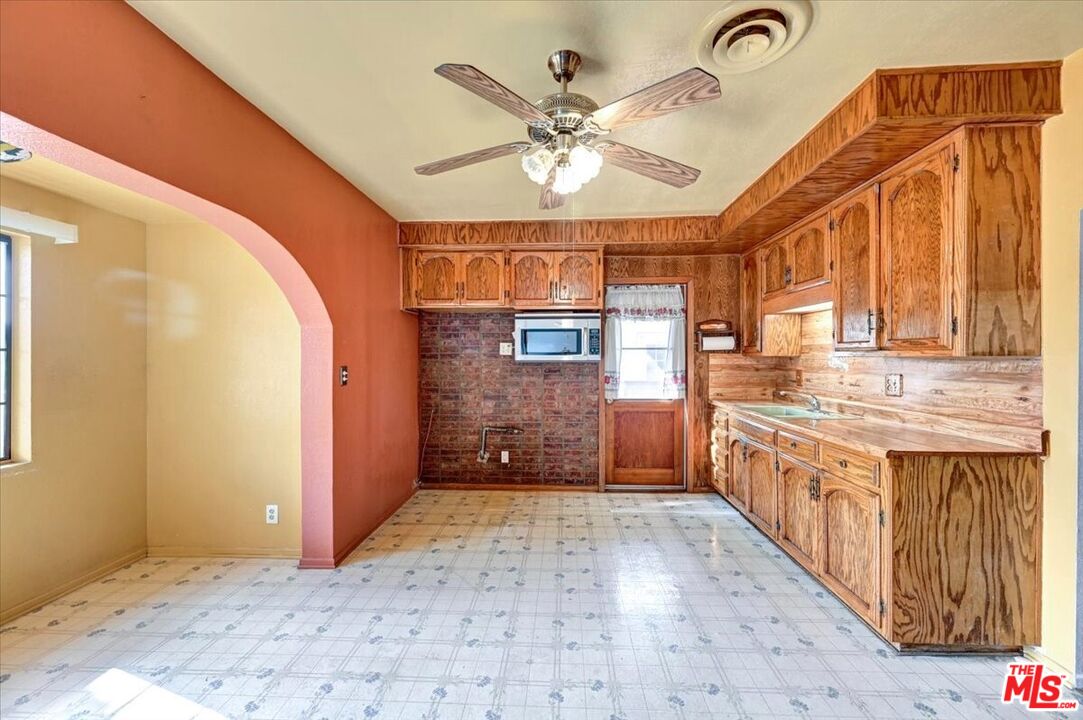 13611 Daventry Street Pacoima, CA 91331 - Photo 11 of 43 a view of a hallway with a chandelier