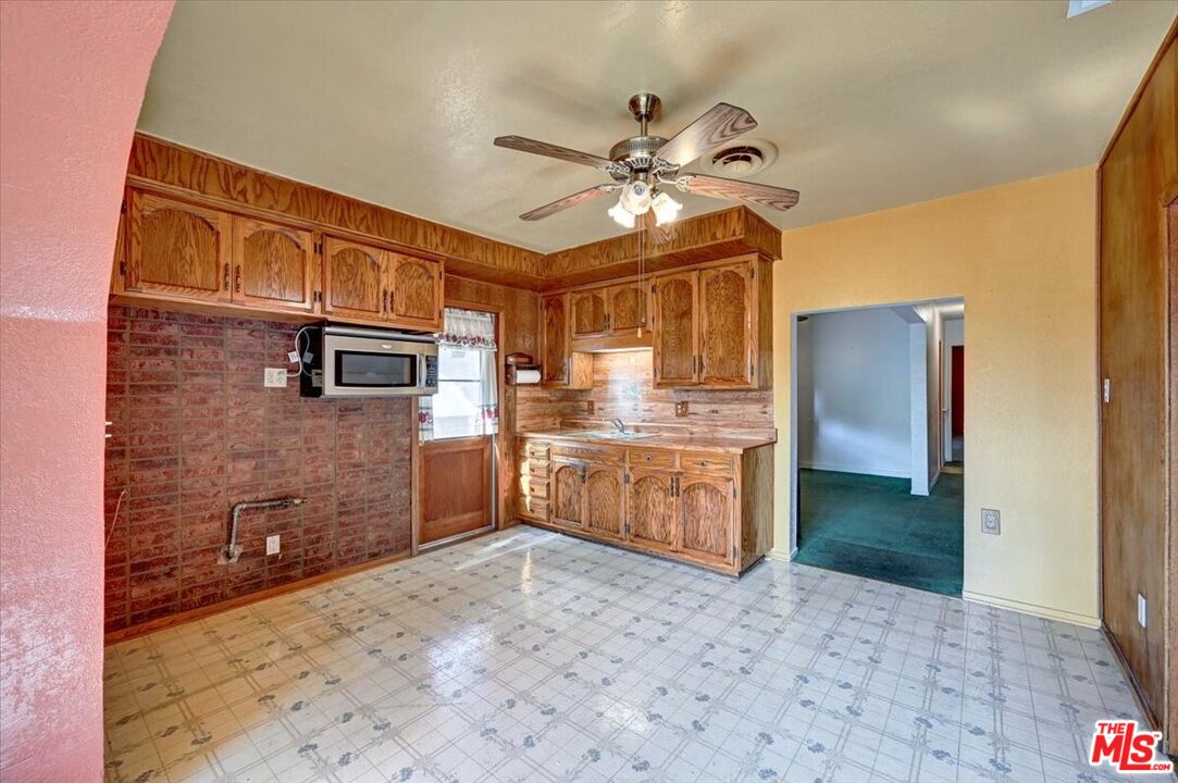 13611 Daventry Street Pacoima, CA 91331 - Photo 12 of 43 a kitchen with stainless steel appliances kitchen island granite countertop a refrigerator and a sink