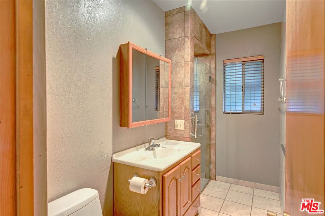 13611 Daventry Street Pacoima, CA 91331 - Photo 16 of 43 a bathroom with a sink toilet and shower