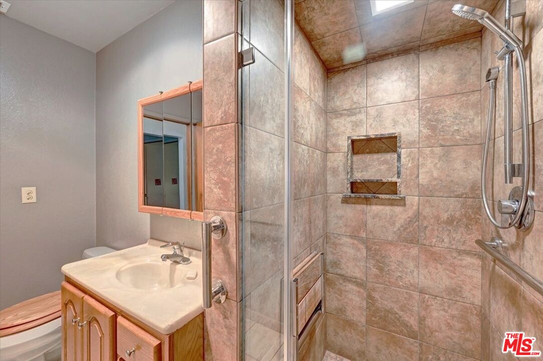 13611 Daventry Street Pacoima, CA 91331 - Photo 17 of 43 a bathroom with a sink shower and a mirror