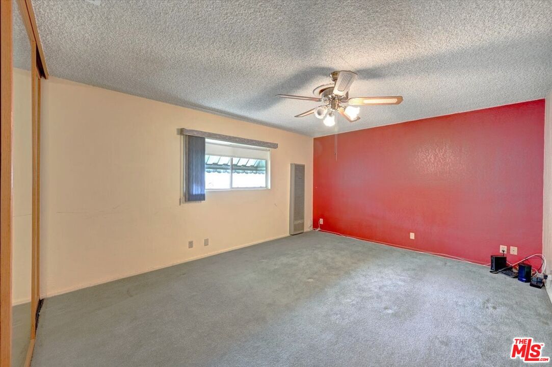 13611 Daventry Street Pacoima, CA 91331 - Photo 18 of 43 an empty room with windows and chandelier fan