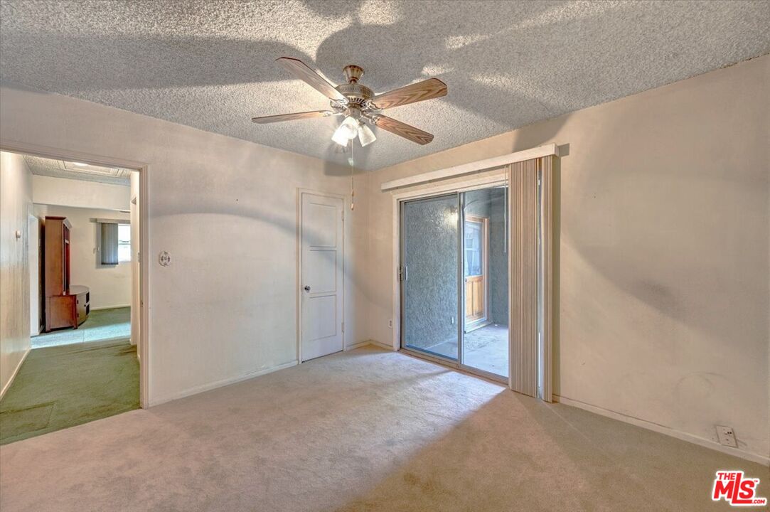 13611 Daventry Street Pacoima, CA 91331 - Photo 20 of 43 an empty room and chandelier fan in hallway