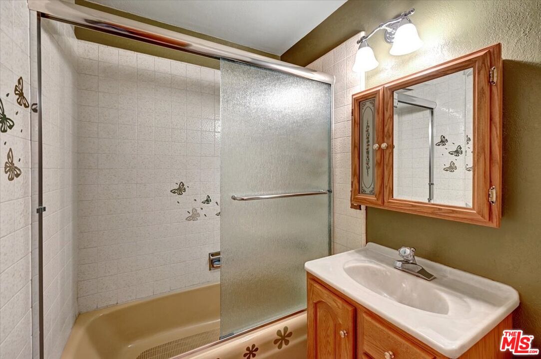 13611 Daventry Street Pacoima, CA 91331 - Photo 23 of 43 a bathroom with a sink and a mirror