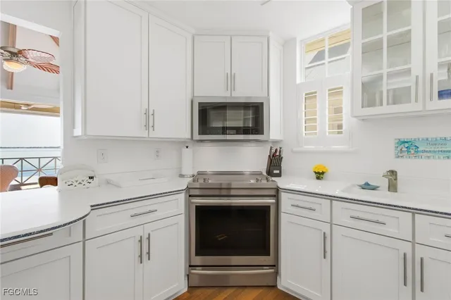 a kitchen with a refrigerator sink and cabinets