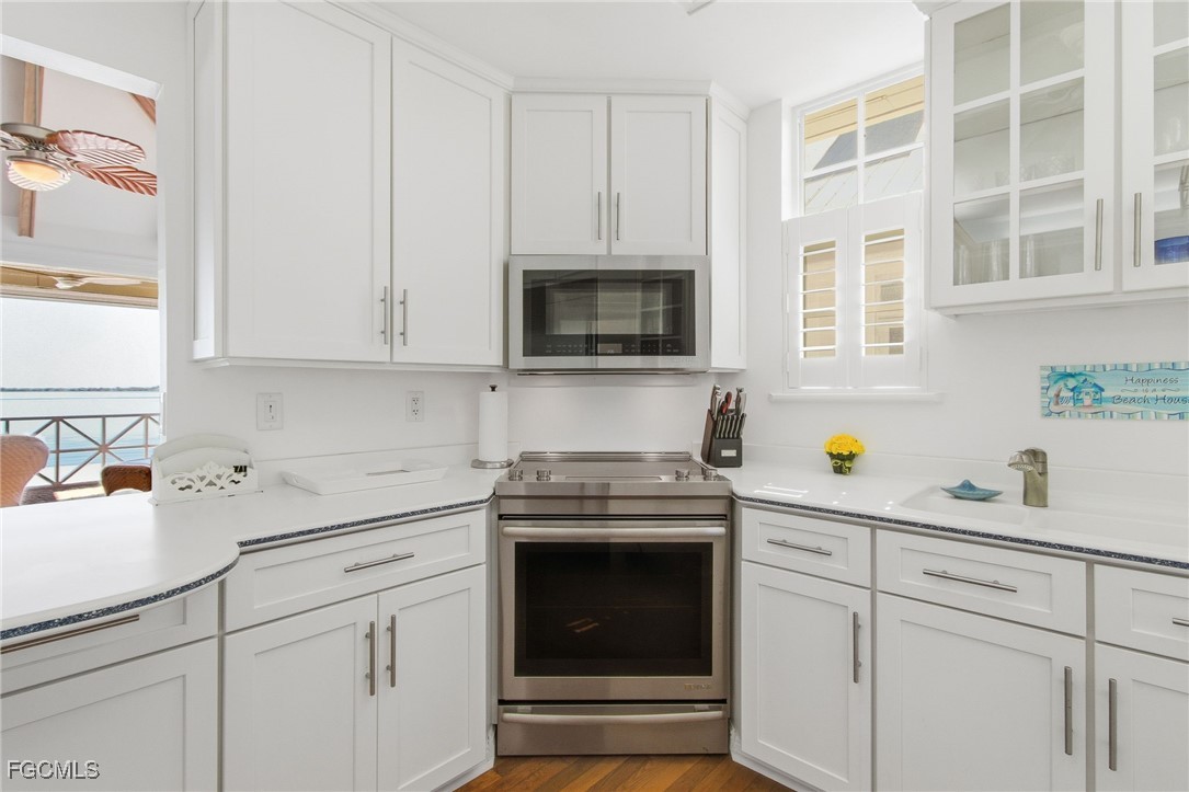 115 Useppa Island Bokeelia, FL 33922 - Photo 17 of 38 a kitchen with cabinets stainless steel appliances and a sink