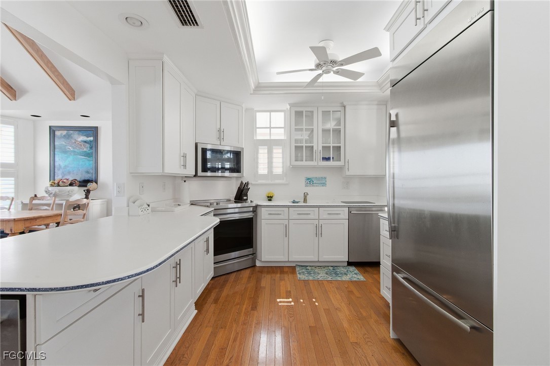 115 Useppa Island Bokeelia, FL 33922 - Photo 19 of 38 a kitchen with a refrigerator sink and cabinets