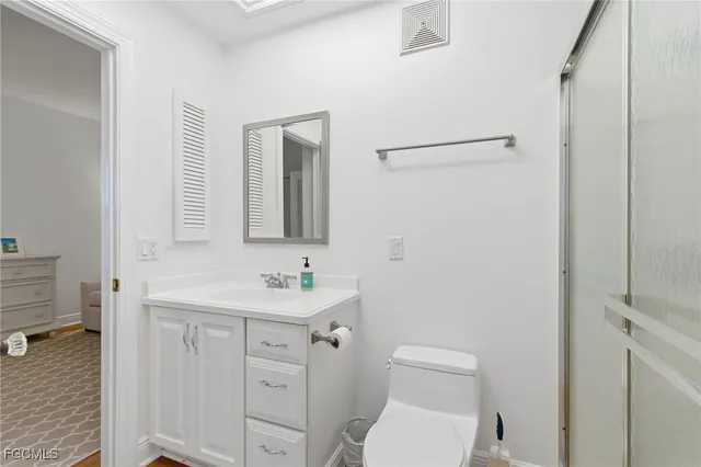 a bedroom with a large bed and a flat screen tv