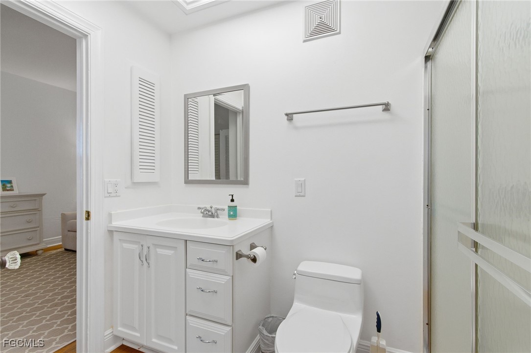 115 Useppa Island Bokeelia, FL 33922 - Photo 21 of 38 a bathroom with a toilet sink and mirror