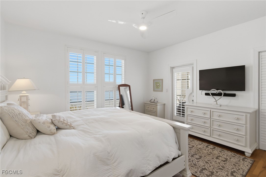 115 Useppa Island Bokeelia, FL 33922 - Photo 23 of 38 a bedroom with a large bed and a flat screen tv
