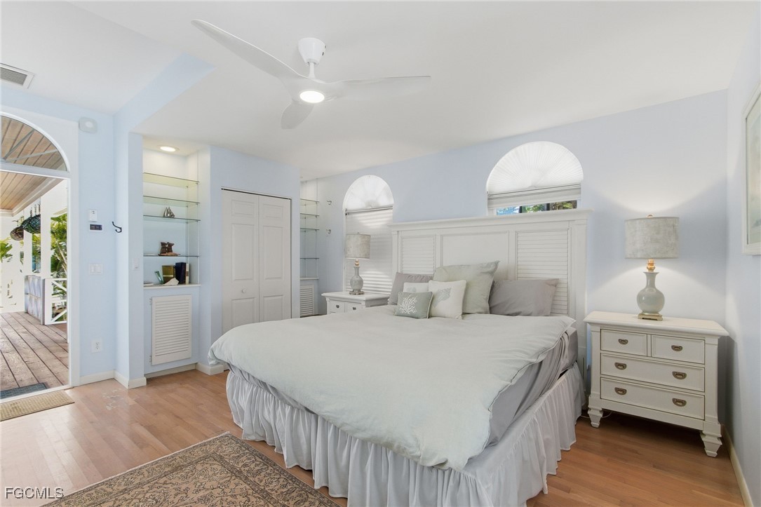 115 Useppa Island Bokeelia, FL 33922 - Photo 28 of 38 a bedroom with a bed and a chandelier