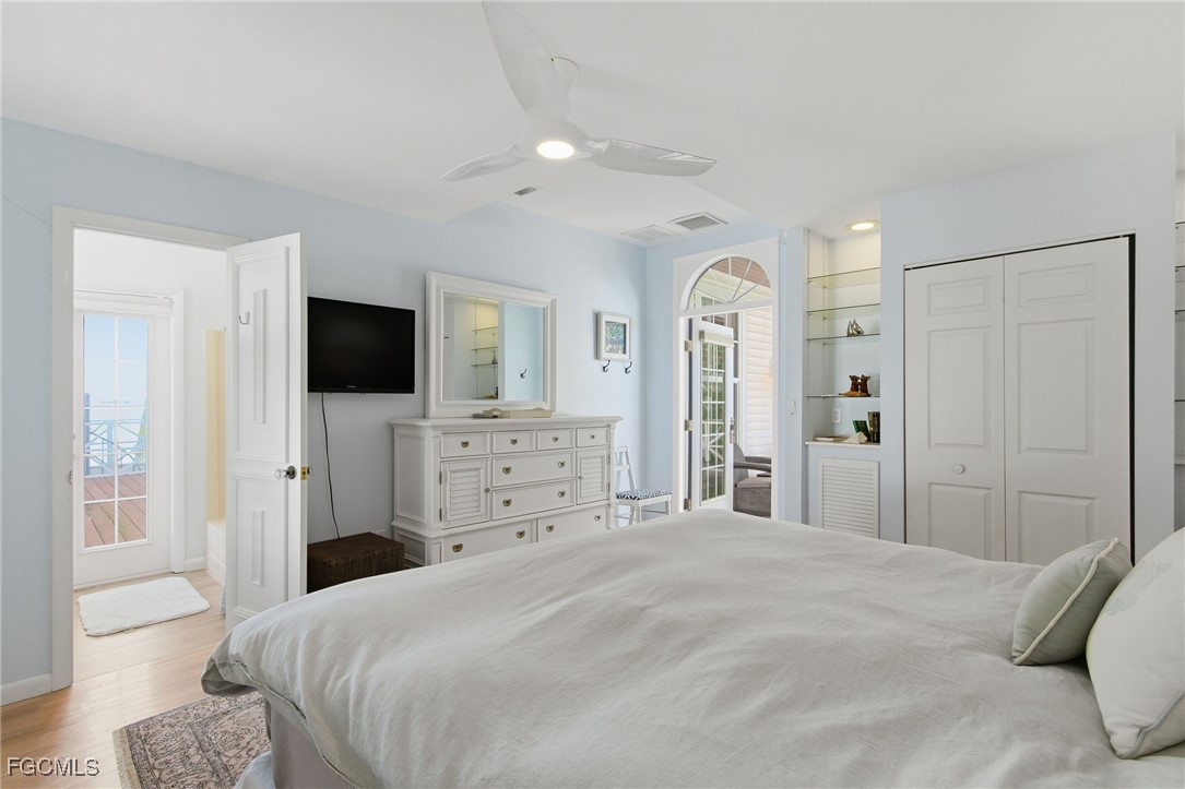 115 Useppa Island Bokeelia, FL 33922 - Photo 29 of 38 a bedroom with a bed and a flat screen tv
