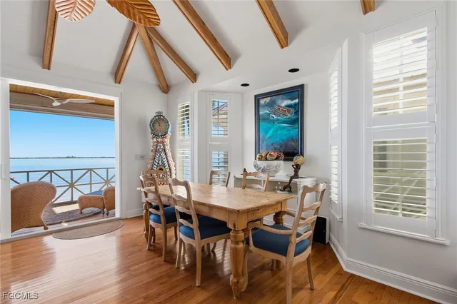 a view of a dining room with furniture window and wooden floor