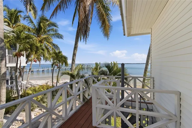a view of a lake with a table and chairs