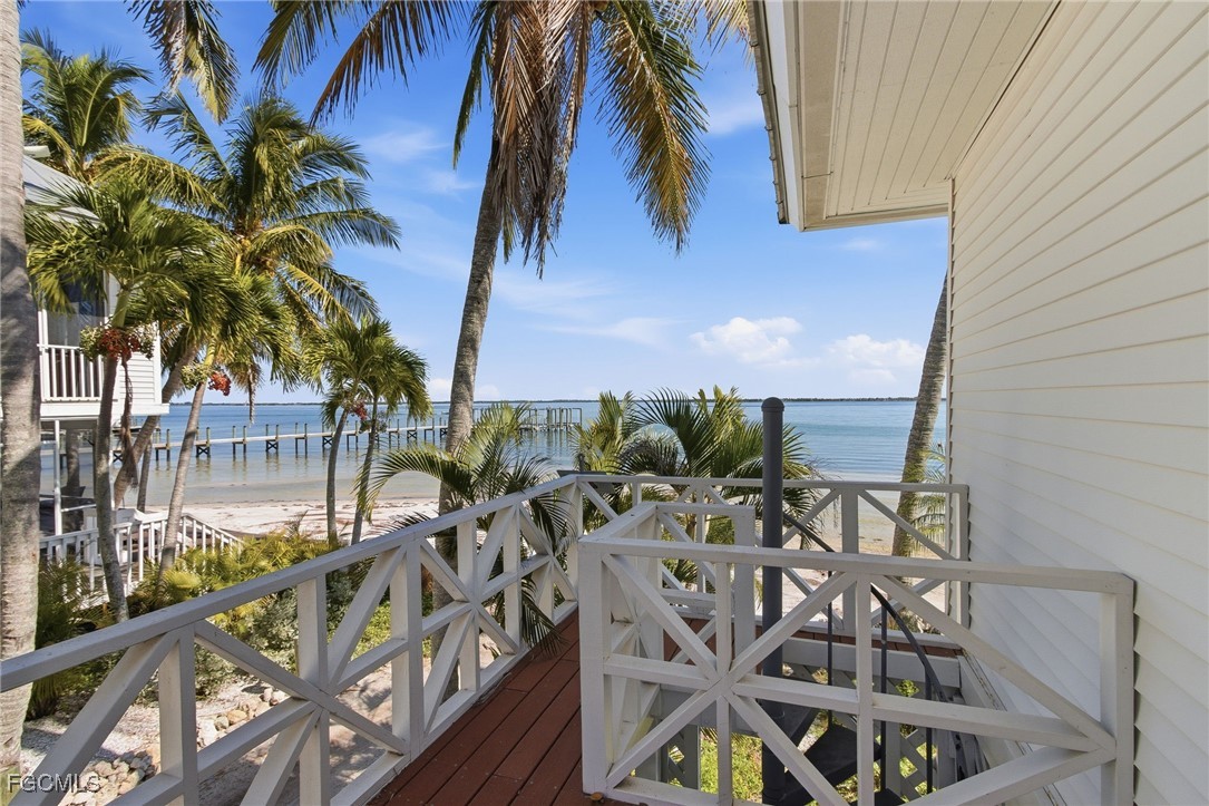 115 Useppa Island Bokeelia, FL 33922 - Photo 33 of 38 a view of balcony with a potted plant and palm trees