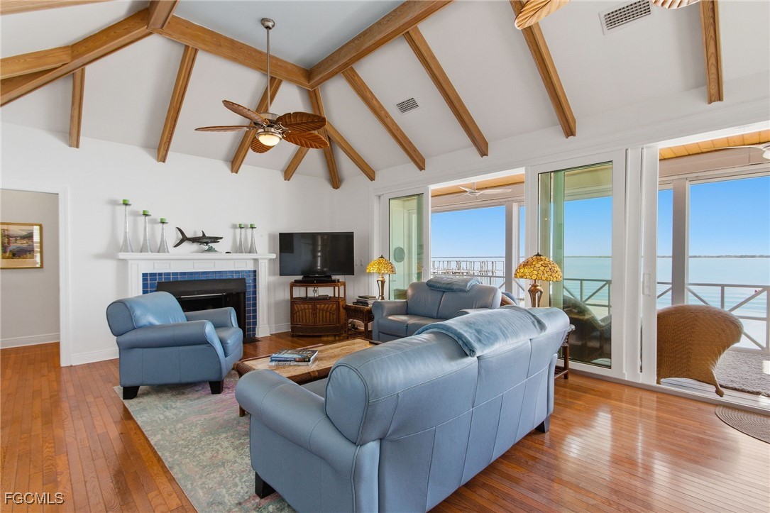 115 Useppa Island Bokeelia, FL 33922 - Photo 4 of 38 a living room with furniture a fireplace and a flat screen tv