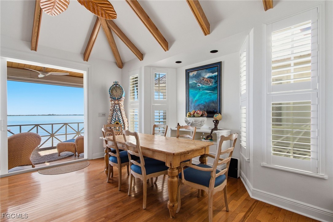 115 Useppa Island Bokeelia, FL 33922 - Photo 5 of 38 a view of a dining room with furniture window and wooden floor