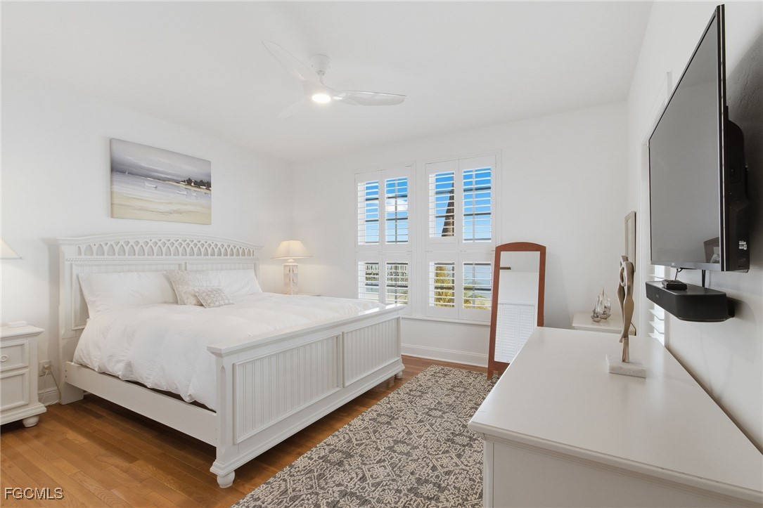 115 Useppa Island Bokeelia, FL 33922 - Photo 7 of 38 a bedroom with a bed and a flat screen tv