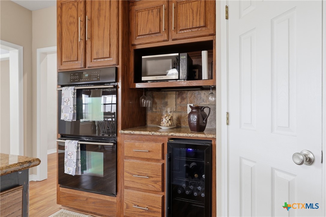 457-459 Buentello Road Victoria, TX 77905 - Photo 11 of 35 a kitchen with granite countertop a stove and cabinets
