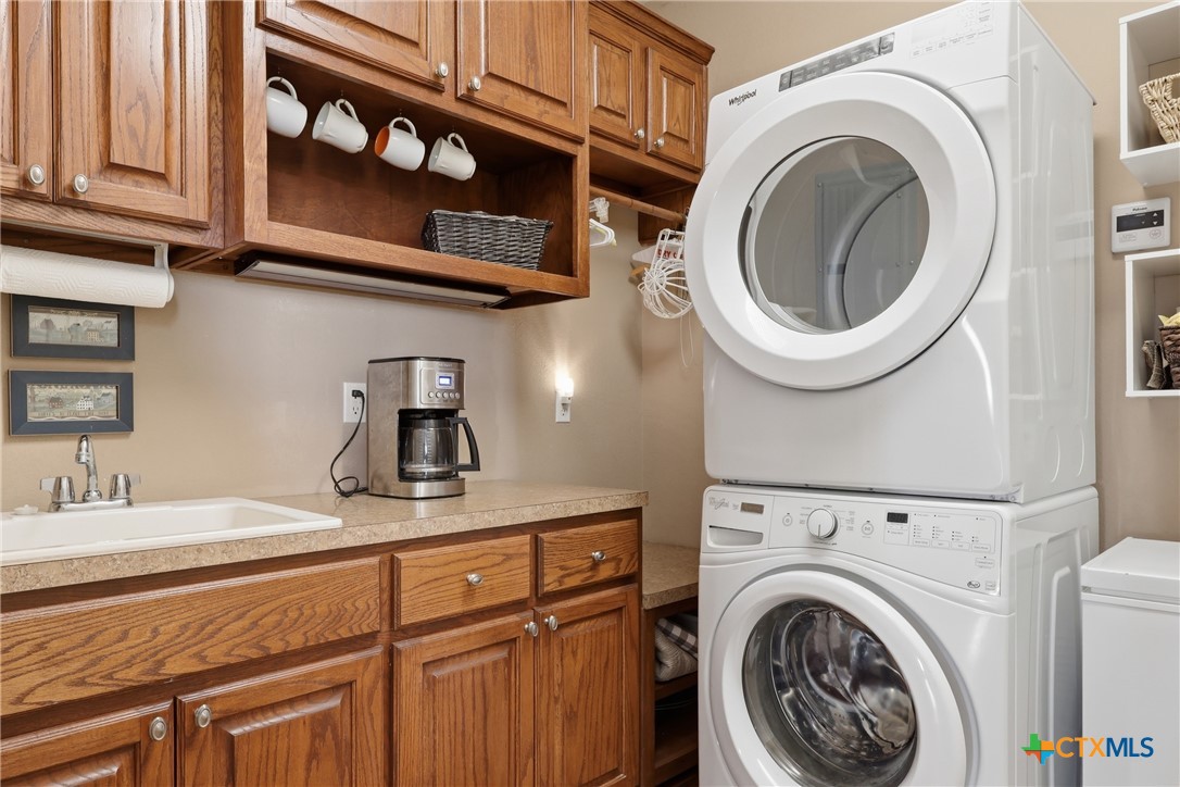 457-459 Buentello Road Victoria, TX 77905 - Photo 13 of 35 a bathroom with a sink a washer and dryer