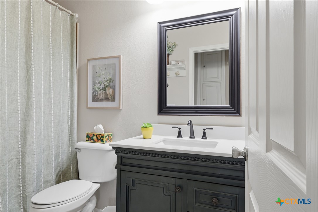 457-459 Buentello Road Victoria, TX 77905 - Photo 25 of 35 a bathroom with a toilet sink and mirror
