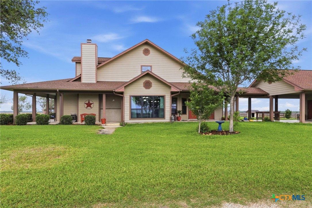 457-459 Buentello Road Victoria, TX 77905 - Photo 29 of 35 a front view of a house with a garden and trees