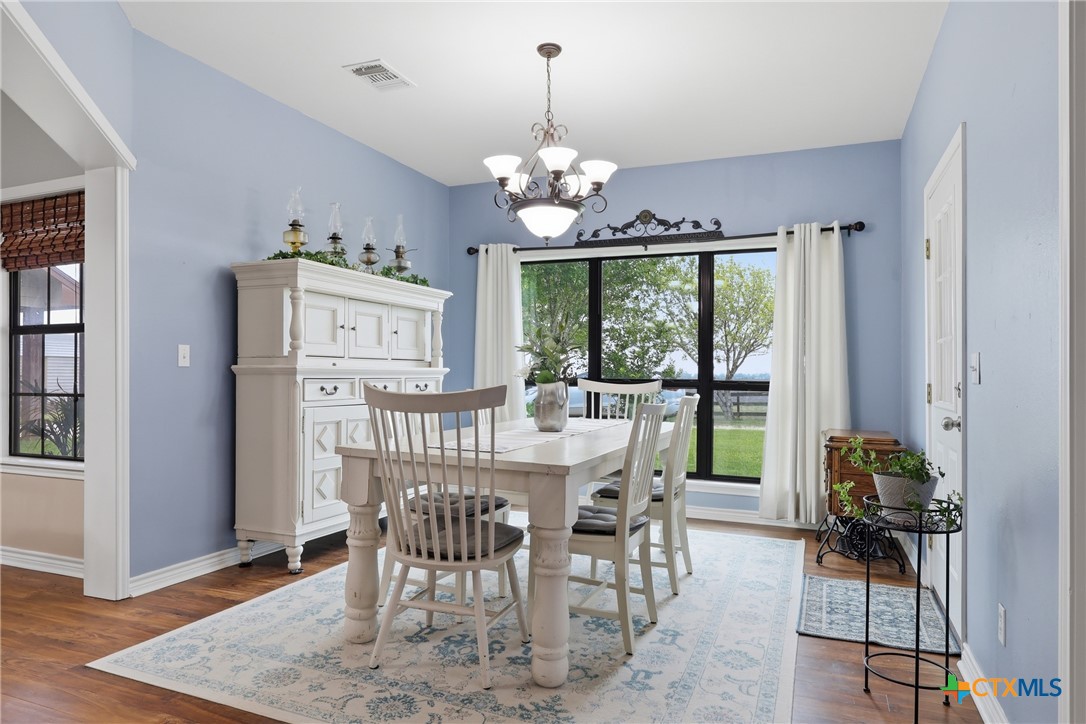 457-459 Buentello Road Victoria, TX 77905 - Photo 6 of 35 a view of a dining room with furniture a chandelier and wooden floor