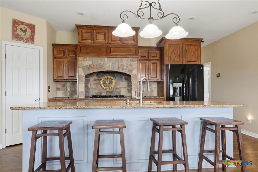 457-459 Buentello Road Victoria, TX 77905 - Photo 8 of 35 a kitchen with cabinets a sink and a fireplace