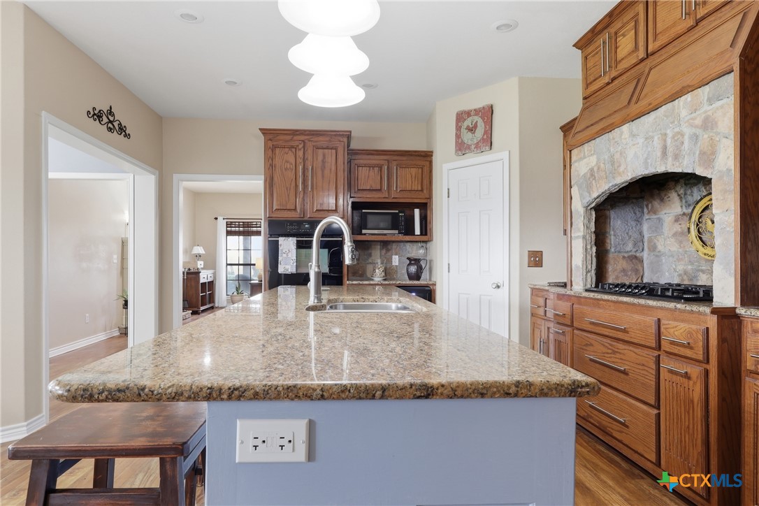 457-459 Buentello Road Victoria, TX 77905 - Photo 9 of 35 a kitchen with granite countertop a sink and refrigerator