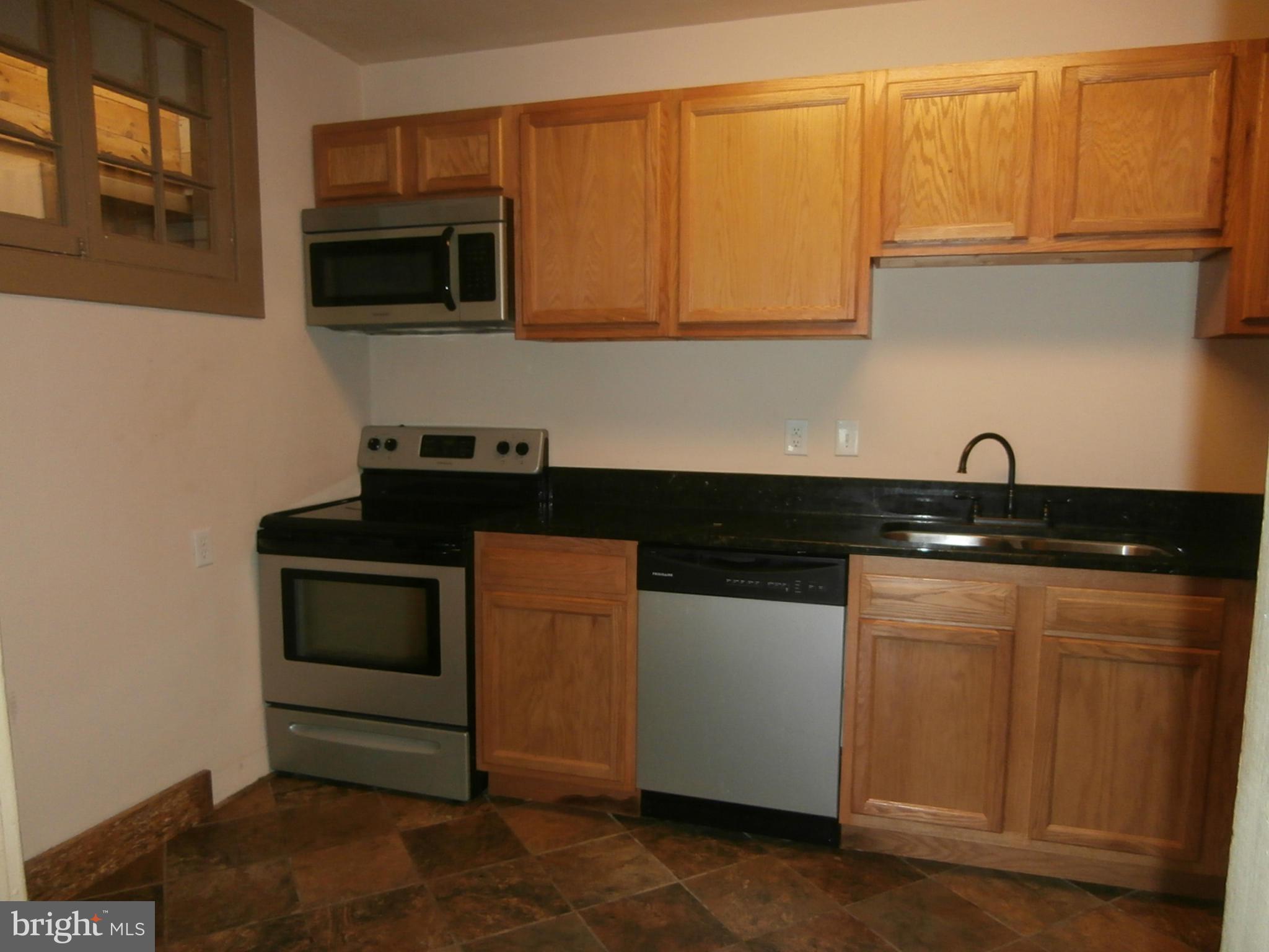 10 Blue Ridge Avenue, Unit 1 Front Royal, VA 22630 - Photo 3 of 7 a kitchen with stainless steel appliances granite countertop a sink and a microwave